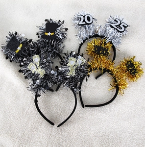 Detail of 2025 New Year party headbands with festive tinsel and glittery decor