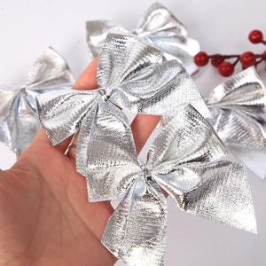 Handheld silver Christmas tree bows with metallic glitter texture for holiday decoration