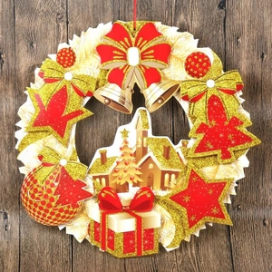 Close-up of Christmas paper wreath with glitter bow, gold bells and holiday elements