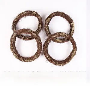 Detailed view of four handmade dark brown wicker wreaths with gold dusting for decor