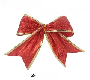 Detail of red glitter Christmas bow with gold ribbon edges for tree decoration
