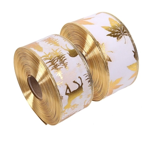Detail of Christmas ribbons with gold elk and maple leaf prints for gift wrapping