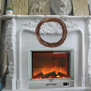 Brown woven rattan wreath displayed over a white marble fireplace for festive decoration