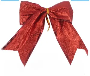 Detail of red glitter Christmas bow with gold wire tie for holiday tree decoration