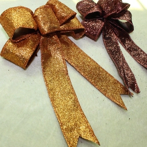 Close-up of glitter Halloween bows in gold and bronze finish for party decor