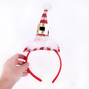 Detail of Christmas headband showing red sequins, white faux fur and mini hat