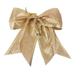 Glittery gold Christmas tree bow ornament with metallic edges for holiday party decor