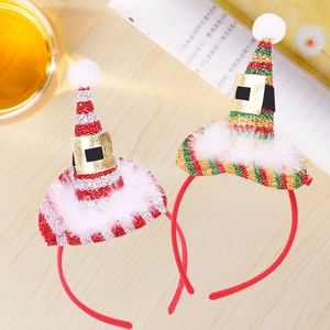 Detail of Christmas elf hat headbands with sequins and plush trim on wooden background