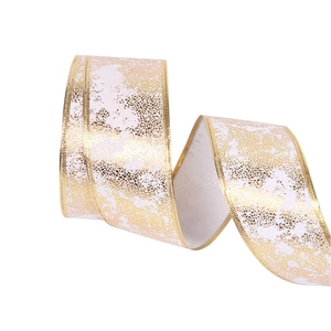 White Christmas ribbon with golden metallic leaf patterns and wired edges for decoration
