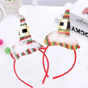 Detail of Christmas elf hat headbands with sequins, white feathers and plush pom-poms
