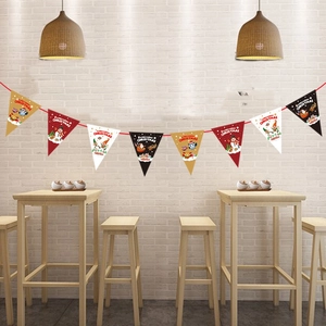 Detail of Christmas triangle pennant banner with Santa and snowman patterns on white brick wall