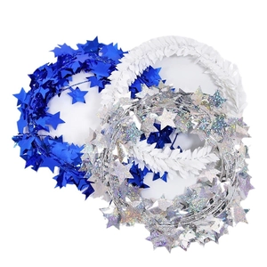 Christmas star tinsel garland in blue, silver laser, and white leaf designs for decor