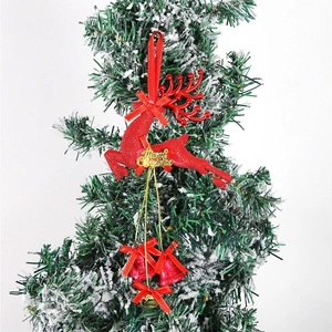 Close-up of red glitter reindeer ornament with gold Merry Christmas sign on Xmas tree