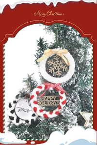 Detailed view of three festive mini wreaths with snowflakes and holiday greetings for the tree
