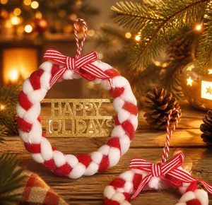 Detail of red and white woven Christmas wreath with gold Happy Holidays glitter text