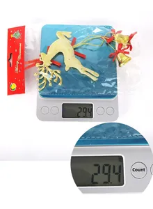 Christmas reindeer hanging ornament with golden bells on scale weighing approx 29.4g