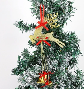 Detail of gold glitter Christmas reindeer ornament with red bow and bells on tree