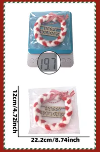 Detail of red and white Happy Holidays hanging ornament with weight and size dimensions