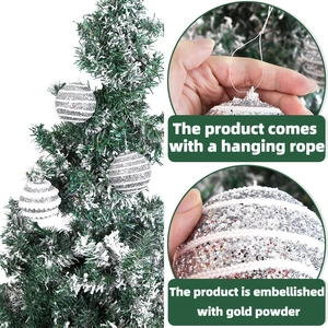 Sparkling silver and white striped Christmas ornaments with sequins hanging on a snowy tree