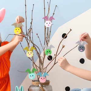 Easter plush bunny ears hanging ornaments with glitter details on decorative branches