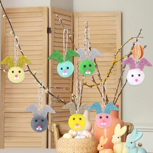 Easter plush bunny ear ornaments with glitter details hanging on spring tree branches