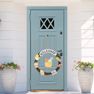 Happy Easter welcome wreath with bunny, eggs and chicks on a blue wooden door