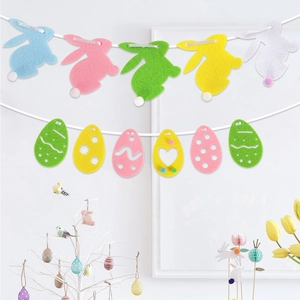 Colorful felt Easter bunny and egg banner hanging in a cozy holiday party setup