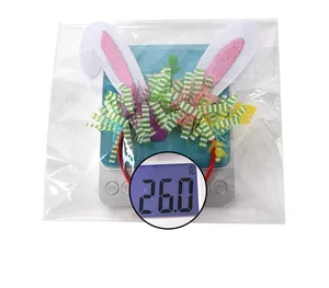 Close-up of Easter rabbit ear headband with pink sequins and green tinsel on scales