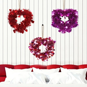 Macro shot of glittery heart-shaped garlands in red and purple for Valentine party decoration