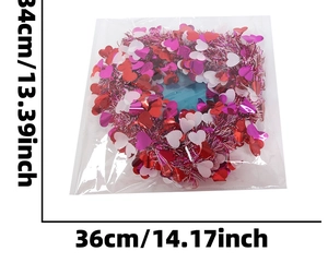 Detail showing heart-shaped garland dimensions 34x36cm in shiny red and pink sequins