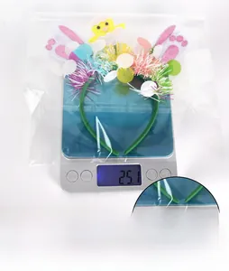 Easter bunny headband with yellow chick and glitter ears shown on a scale for weight display