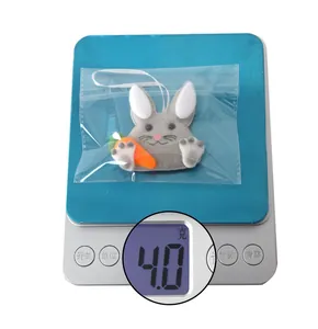 Detail of felt Easter bunny ornament holding a carrot weighing 4g on a scale