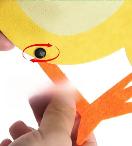 Close-up of Easter chick pendant showing 360-degree rotating body parts with a black fastener