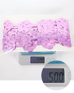 Detail showing the 50g weight measurement of a pink holographic petal foil curtain