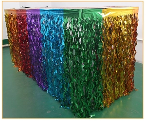 Close-up of rainbow metallic foil table skirt with wavy tinsel fringes for party decor