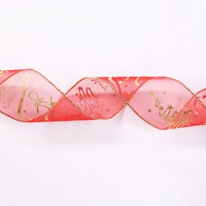 Detail of red mesh Christmas ribbon with gold Merry Christmas print and wired edges