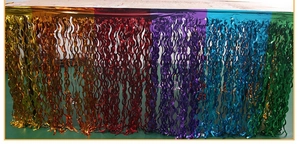 Close-up of rainbow wavy fringe tinsel table skirt for birthday and party decorations