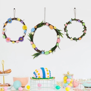 Close-up of three Easter wreaths featuring colorful eggs, daisies, and green leaves on rattan