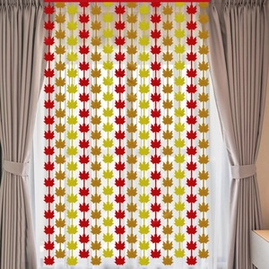 Close-up of autumn maple leaf garland with red and yellow felt leaves for festive decor