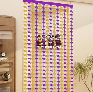 Detail of purple and gold graduation mortarboard curtain hanging on a white door frame