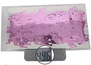 Pink glitter crown party decorations being weighed on an electronic scale for weight accuracy