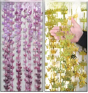 Macro detail of laser cut crown fringe curtains in purple and gold holographic glitter film