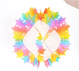Close-up of rainbow gradient maple leaf honeycomb hanging decoration for festive parties
