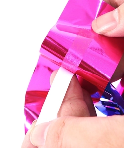 Close-up of metallic pink and blue foil curtains for mermaid themed party decorations