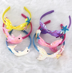Close-up of ocean-themed children's headbands featuring sequins, starfish and dolphins