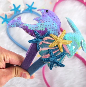 Detail of sequined dolphin and starfish decorations on the ocean themed headbands