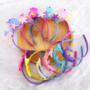 Ocean themed kids headbands with sequin dolphins, stars and mesh on a tray