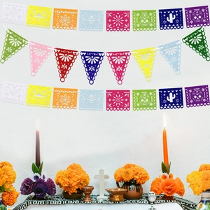 Colorful Mexican Papel Picado banners with hollow floral and skull patterns for Dia de los Muertos