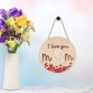Detail of round wooden Mother's Day plaque with I love you mom text and handprint