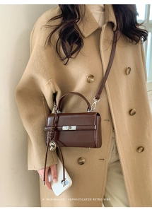 Detailed view of brown litchi pattern PU leather strap with adjustable D-ring buckle